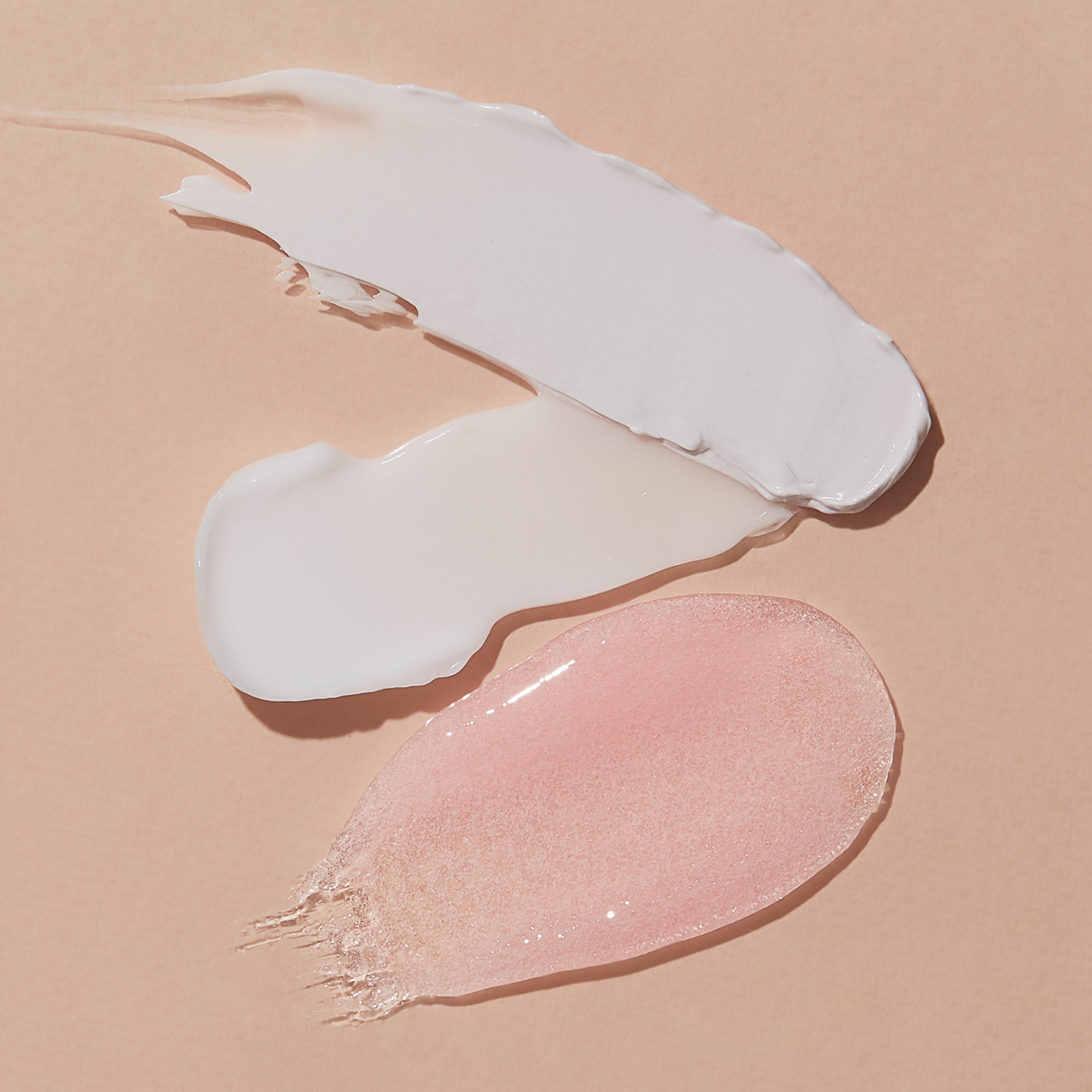 Texture swipes of each step of Mani Moments Vitamin Recharge on a pink background.