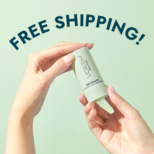 solemate being held by two hands with a free shipping banner arching over top