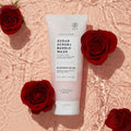 Blossom Bliss Sugar Scrub + Bubble Wash in water on pink background with roses