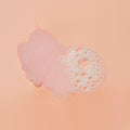 Texture of sugar scrub with bubble on pink background