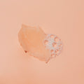 Texture of sugar scrub with bubble on orange background