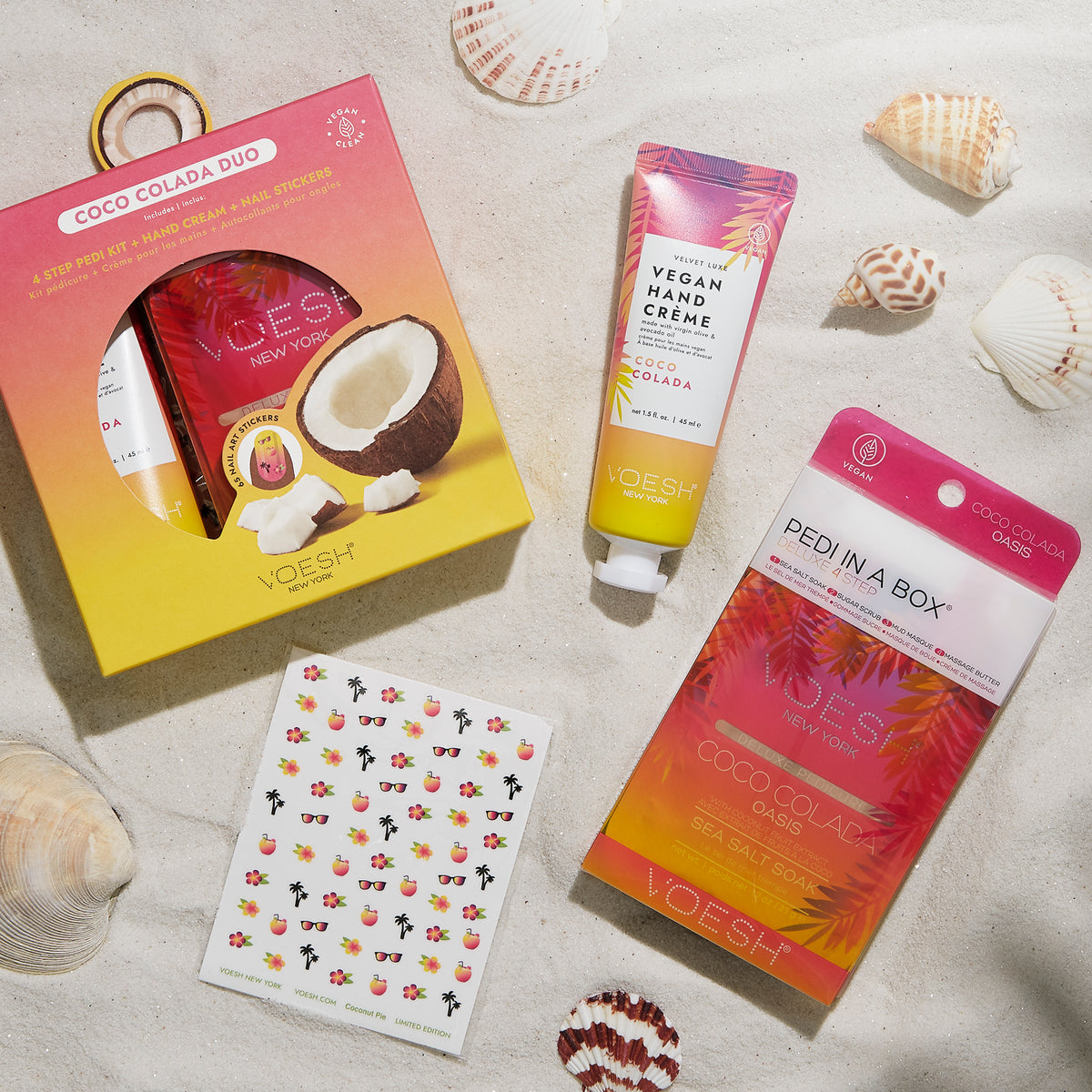 Flatlay of Coco Colada and Nail Art Stickers in the sand