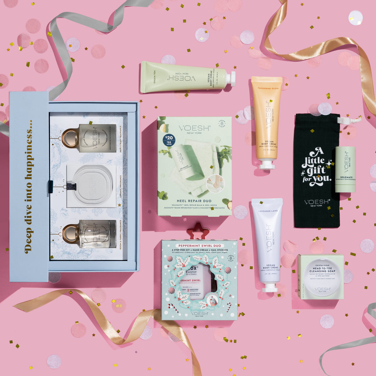Fragrance set, Lotions, Solemate Heel Repair Balm, Peppermint Swirl Duo, Crystal Clear Soap on a flatlay pink background with various ribbons and confetti surrounding the products