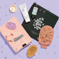 VOESH New York Holiday Pure Shower Bliss holiday kit, laid out on top of a purple starred background.
