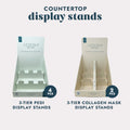 Two Countertop Display Stands, one for pedicure kits and one for collagen treatments, on a grey background.
