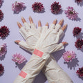 Womens arm with tan polish wearing Elbow high gloves