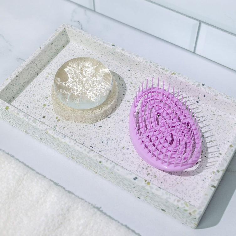 Crystal Clear Head-To-Toe Cleansing Soap on top of the Natural Loofah Soap Dish next to the Scalp Massager.