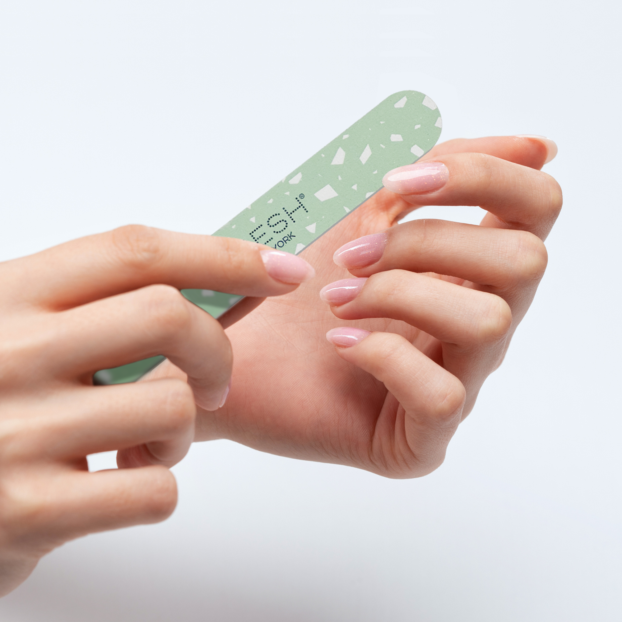 Woman’s hand holding voesh nail file