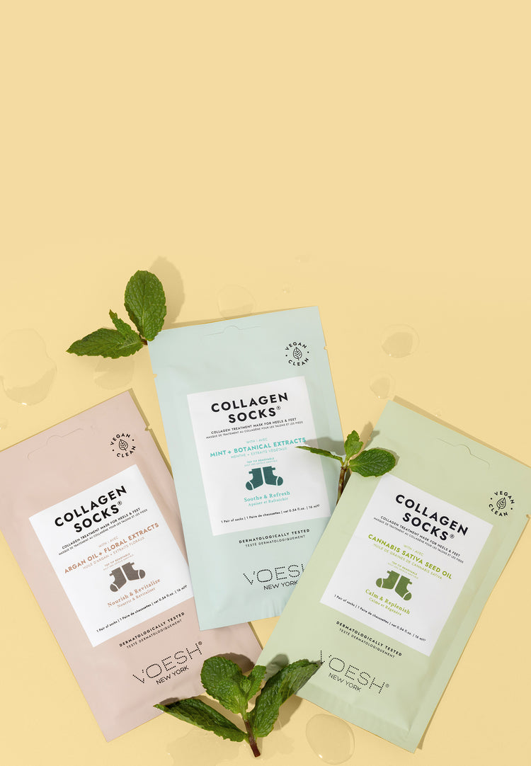 Collagen Socks Argan Oil + Floral Extracts, Collagen Socks Mint + Botanical Extracts, and Collagen Socks Cannabis Sativa Seed Oil on a yellow background with mint leaves. 