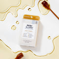 Milk and Honey Pedi In a Box 6 Step flatlay with milk and honey droplets and honeycomb stick