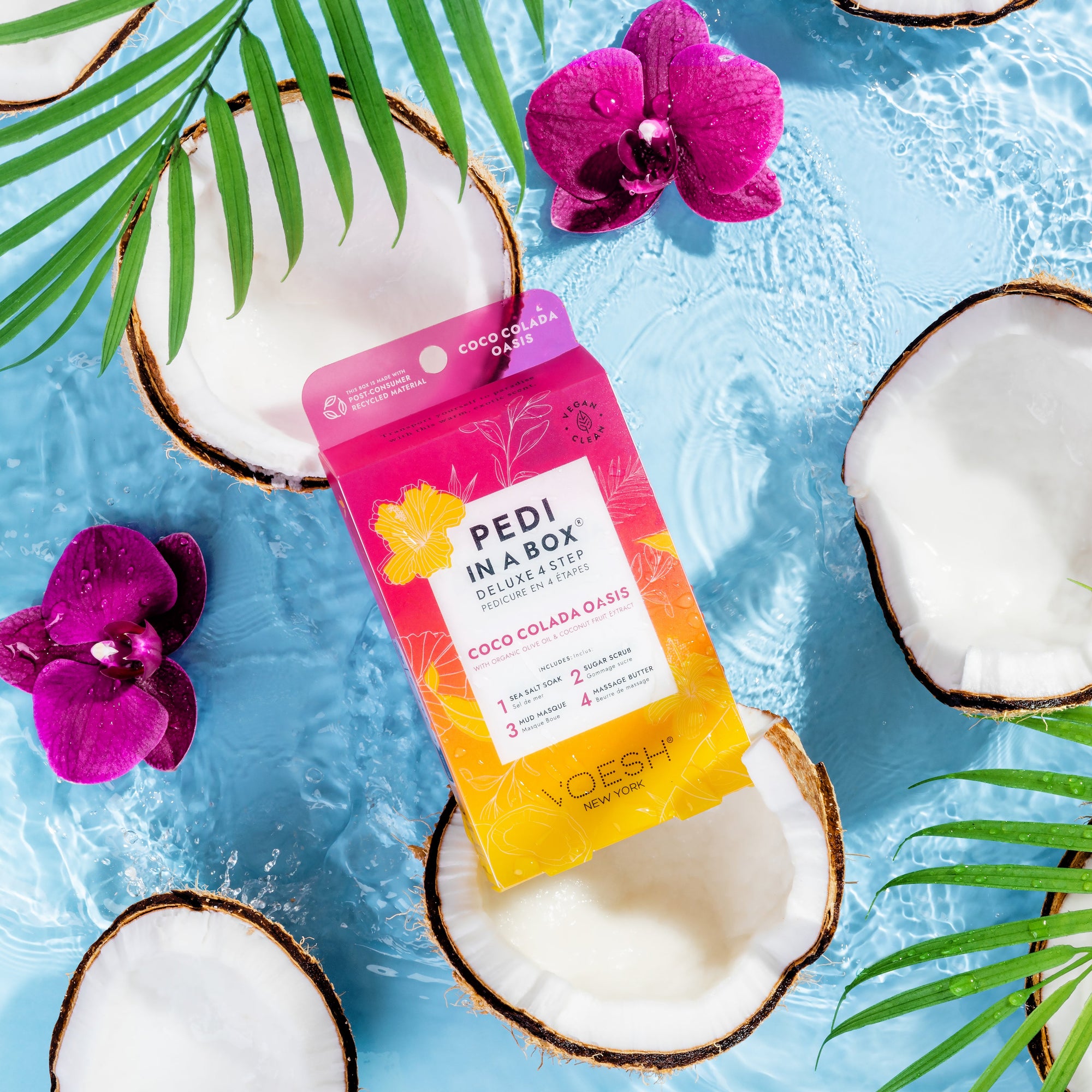 Coco Colada Pedi In a box 4 step in water with tropical flowers, coconut halves, and palm leaves on blue background