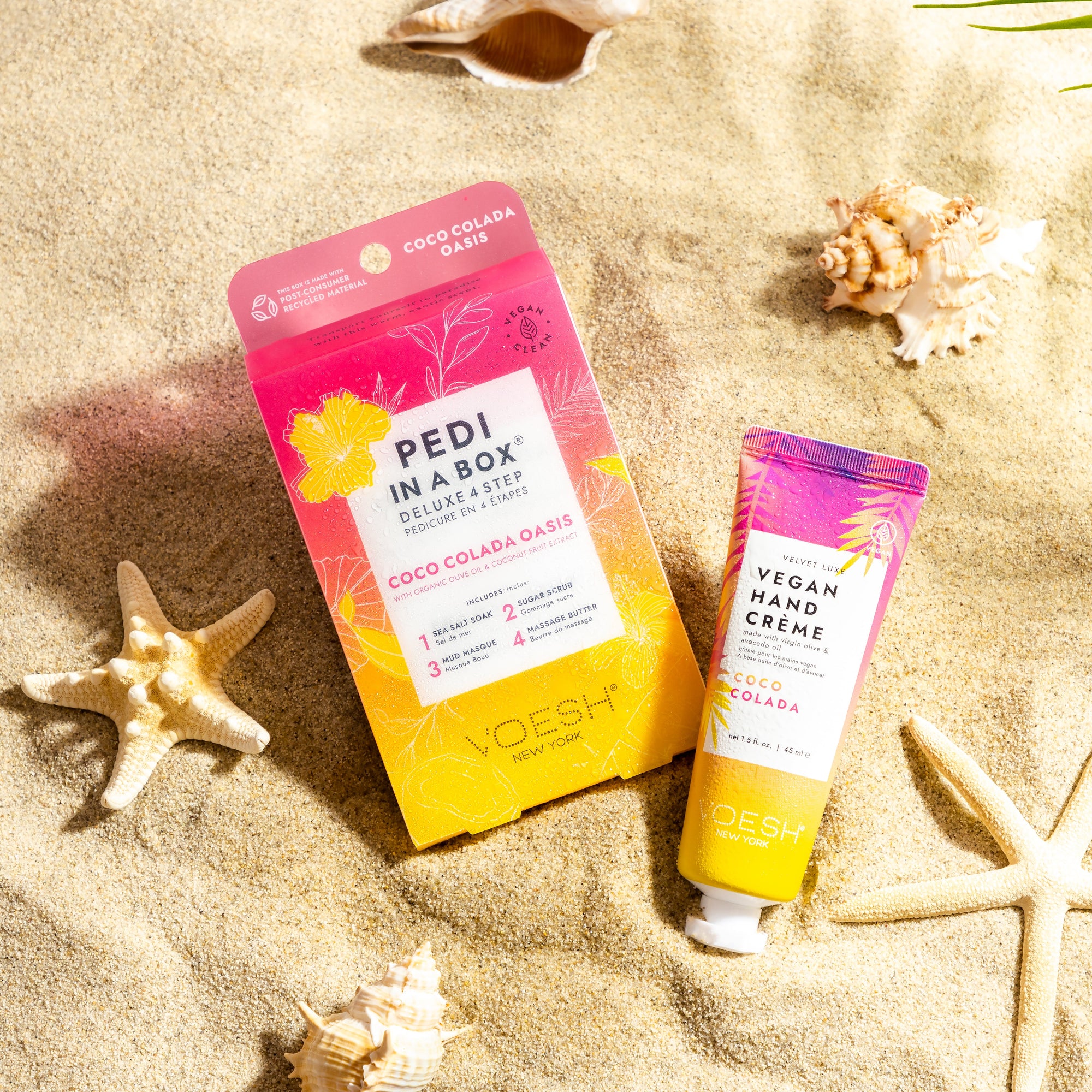 Coco Colada Ped In a Box 4 Step and Vegan Hand Creme in sand with seashells surrounding the background