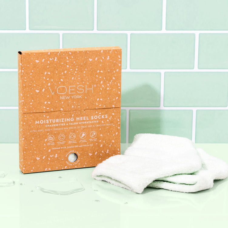 Voesh moisturizing heel sock on a counter with packaging.