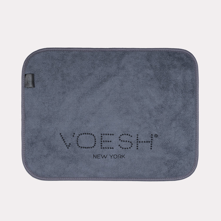 Grey Voesh microfiber pedi towel on gray background
