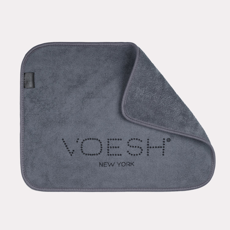 Grey Voesh microfiber pedi towel folded in right corner on gray