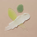 Product texture of Scrub Mud masque, Massage butter on tan background