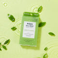 Pedi in a box 3 step green tea detox box on green background in water with green tea leaves