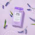 Pedi in a box 3 step lavender relieve in water on purple background with lavender branches