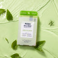 pedi in a box 4 step green tea detox in water on green background with green tea leaves