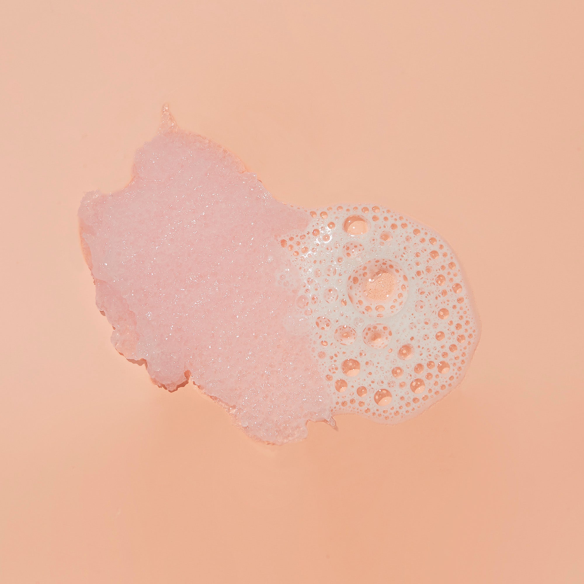 Texture of sugar scrub with bubble on pink background