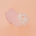 Sugar scrub texture with bubble on pink background