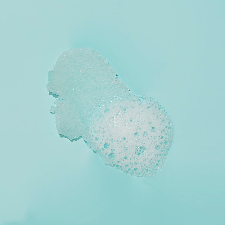 Texture of sugar scrub with bubble on blue background