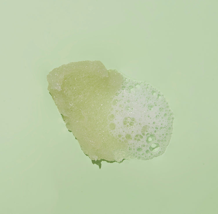 Sugar scrub texture with bubble on green background